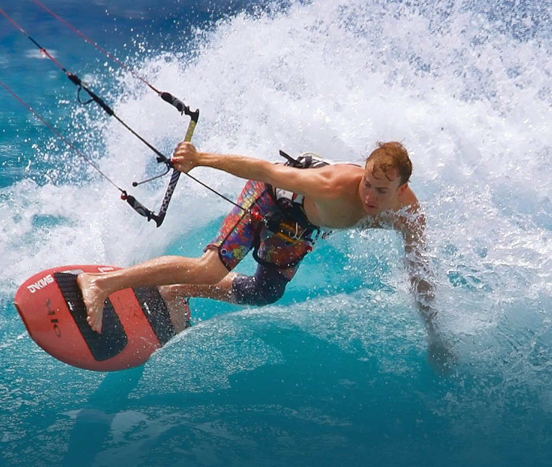 Kitesurfer riding a wave