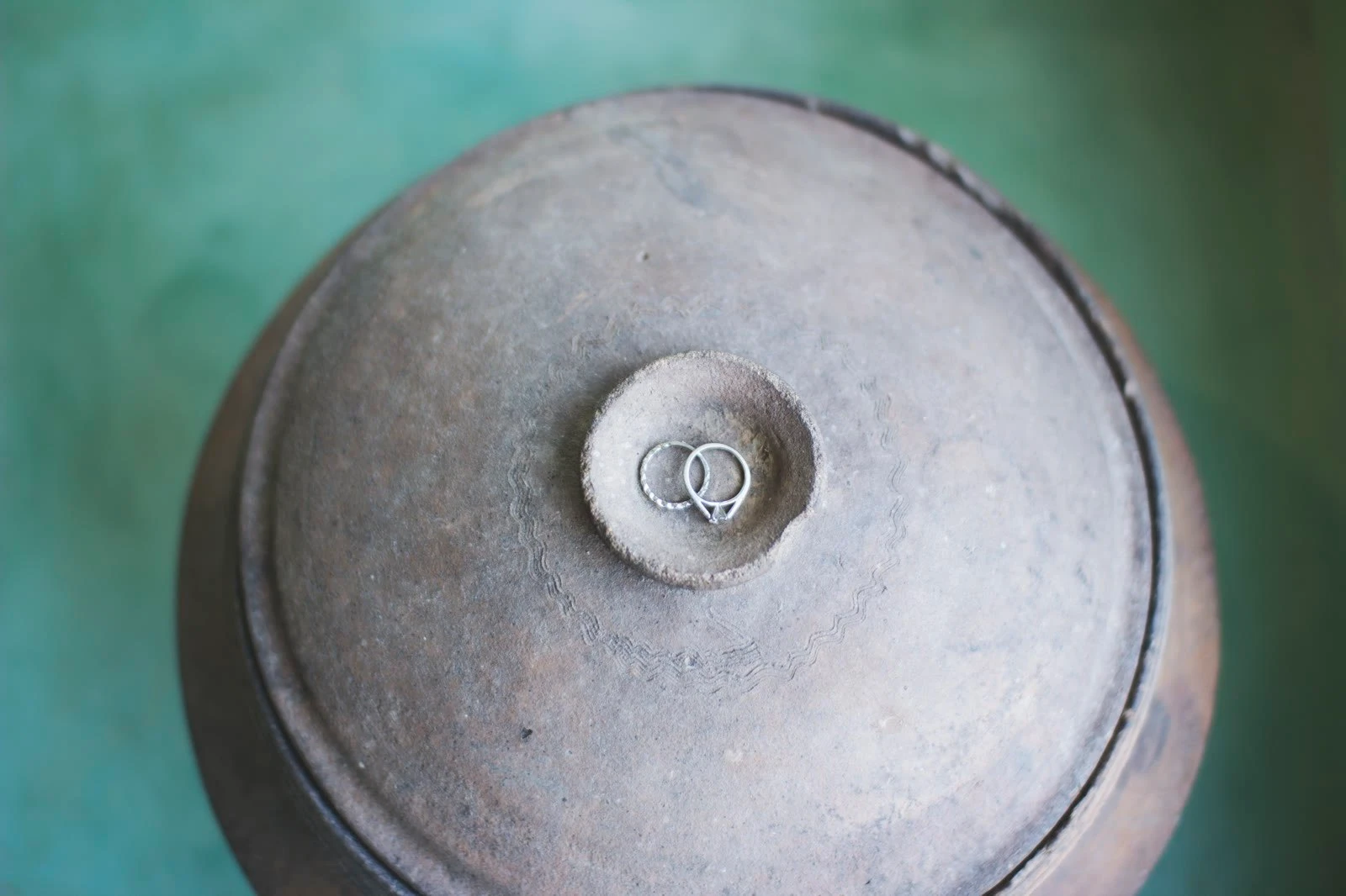 Wedding rings on a Khmer clay pot