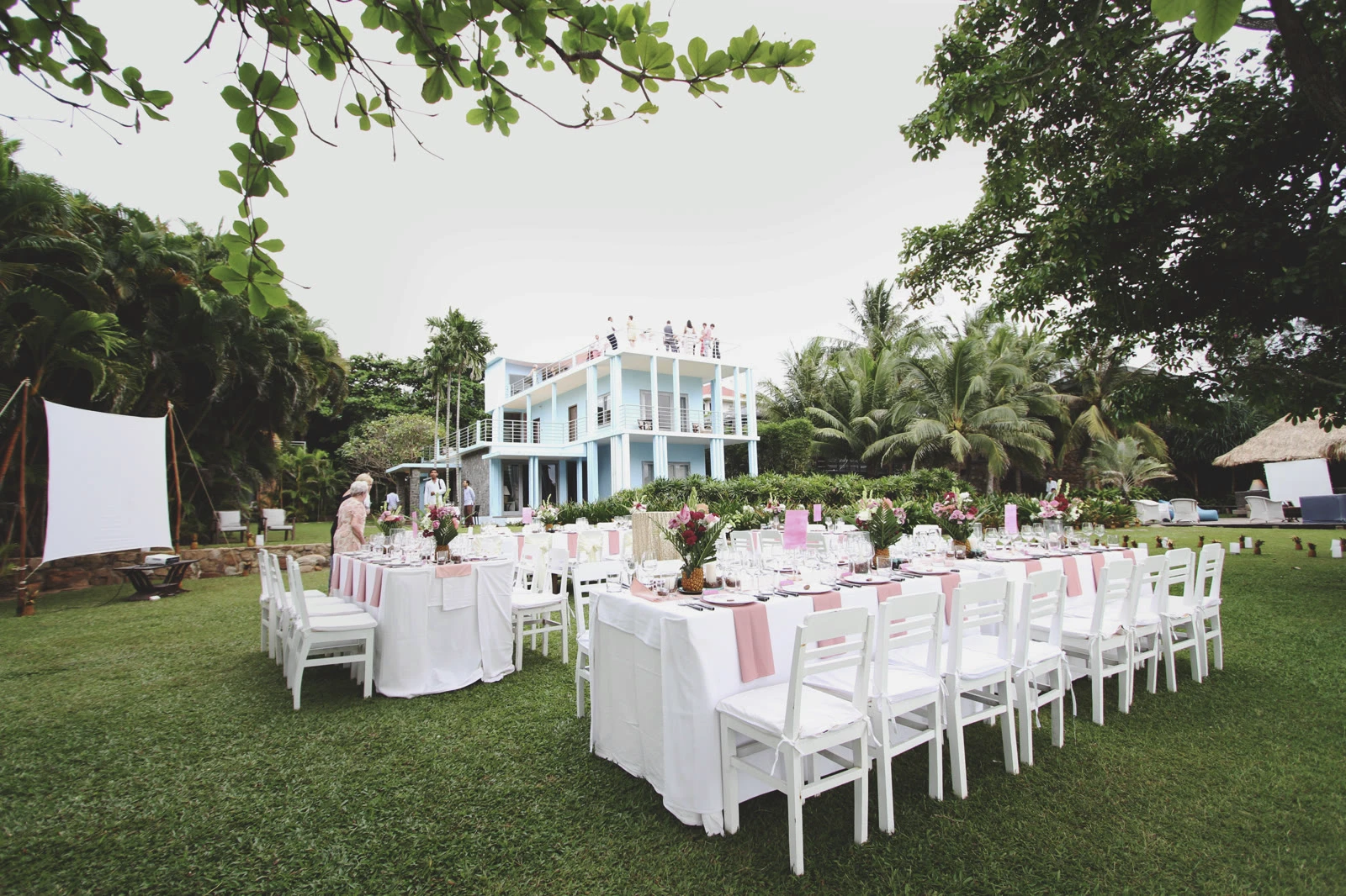 Wedding tables set on the lawn at Knai Bang Chatt